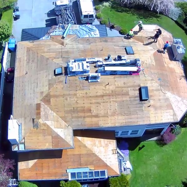 Drone view of the Corevia crew working on a stripped roof deck during a tear off